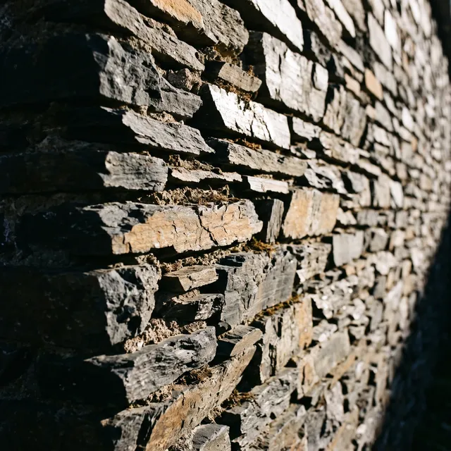 Slate wall photographed at an angle in hard sunlight